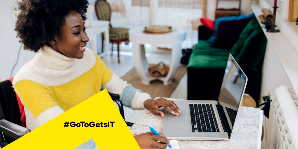 Woman working on a laptop from home with applications updated by patch management