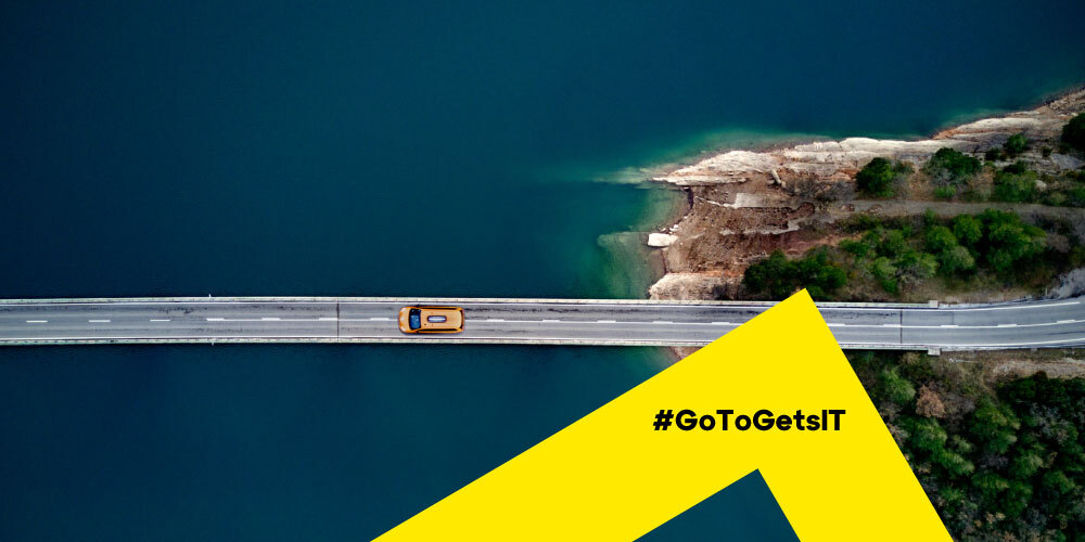 Vista aérea de un coche conduciendo por un puente como metáfora del funcionamiento correcto de una infraestructura de TI gracias a una lista de comprobación para la auditoría de gestión de parches